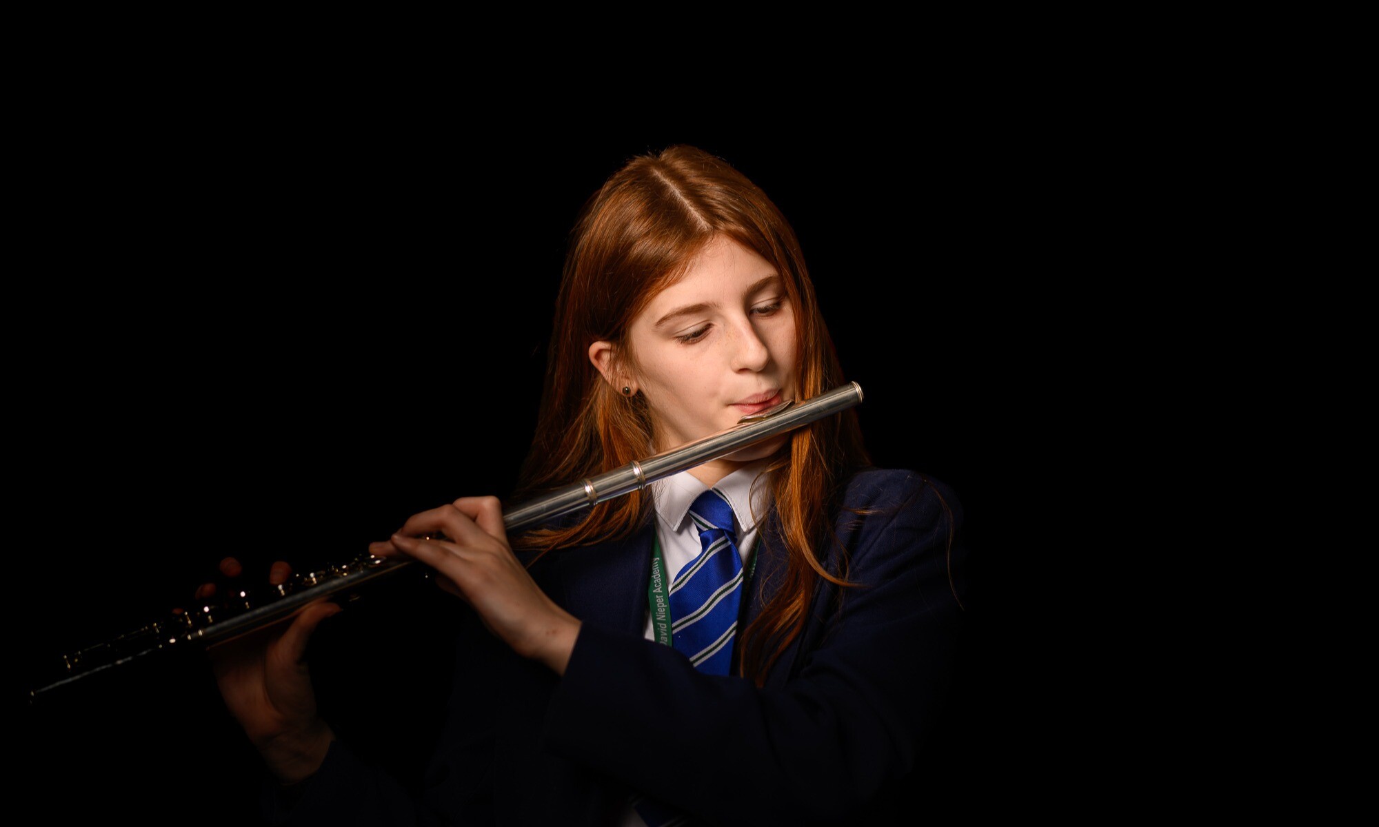 Student Playing the Flute on stage
